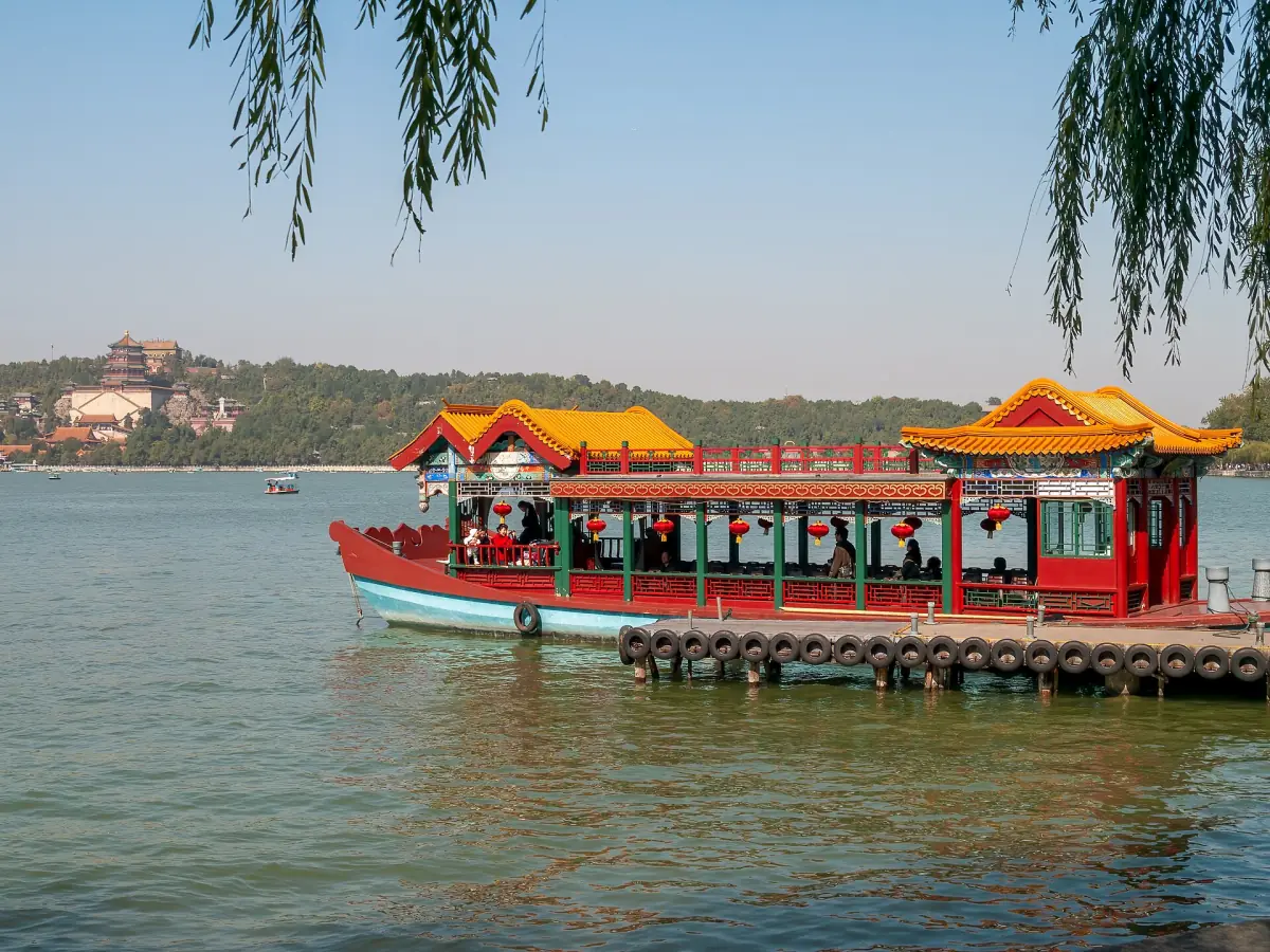 A ferry passing under willows